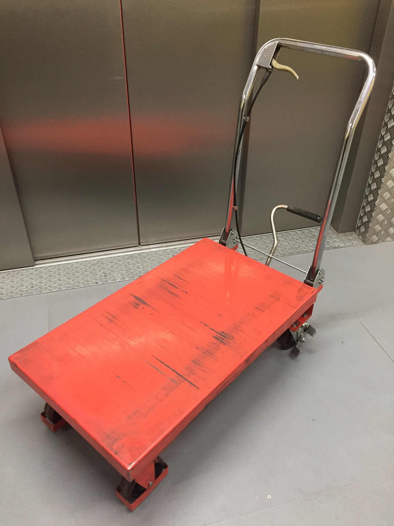 Row of warehouse trollies lined up in a storage area